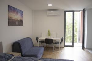 a living room with a table and a blue chair at City center apartment in Koper