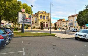 a parking lot with cars parked in front of a building at Industrial loft centre ville Orange clim wifi in Orange