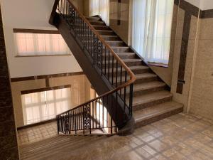 a spiral staircase in a building with windows at Chambre Equipè à louer in Courrendlin +11 photos