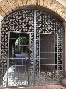 ein Gebäude mit einem Fenster, durch das eine Person hindurch geht in der Unterkunft Il Convento Alghero in Alghero