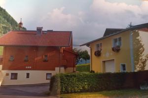 a house and a building with a church in the background at Kaserer in Bruck an der Großglocknerstraße