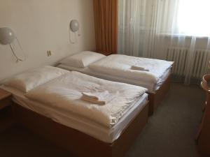 Posteľ alebo postele v izbe v ubytovaní Tatra Hotel