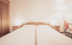 Ein Bett oder Betten in einem Zimmer der Unterkunft Hotel Alte Post by Mountain Hotels