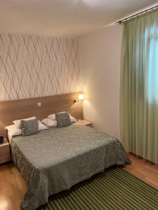 a bedroom with a bed and a large window at Apartments Radulovic in Kotor