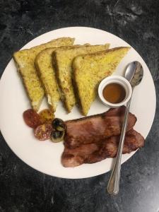 a white plate of food with meat and toast at Marle' Lodge in Germiston