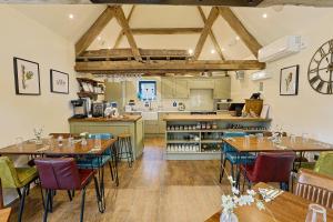 a kitchen and dining room with tables and chairs at The Grange in Upper Arley