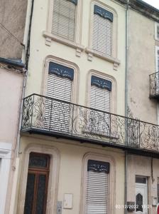 ein Gebäude mit einem Balkon auf der Seite in der Unterkunft Appartement 1er etage proche des Termes in Bourbonne-les-Bains