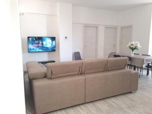 a living room with a couch and a table at Savannah Charme Apartment in La Spezia