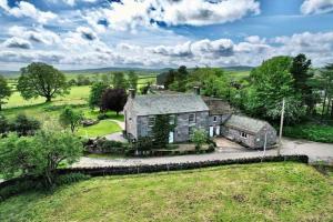 an old house in the middle of a field at Stunning barn minutes from the Lake District in Penrith