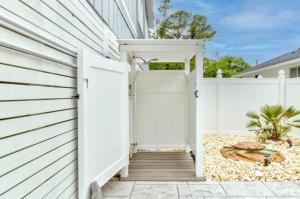 an entrance to a house with a white fence at Ocean Isle Hidden Retreat in Ocean Isle Beach
