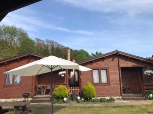 a house with an umbrella in front of it at Cattleya 2 in Wicko