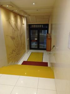 a room with yellow and red mats on the floor at Casa RA in Bari