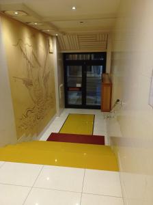 a room with yellow and red mats on the floor at CasaRA in Bari +37 photos