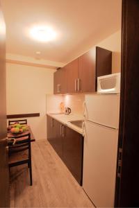 a kitchen with a white refrigerator and a table at Old Plovdiv House in Kapana Area in Plovdiv