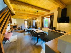 a kitchen and living room with a table and chairs at Rustic Comfort House in Miercurea-Ciuc