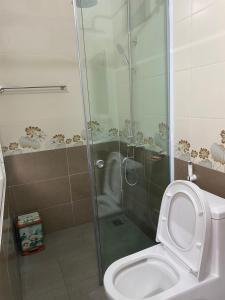 a bathroom with a shower with a toilet and a shower at Nhà Nghỉ Hương Trà Minh Đài 
