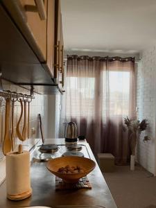 a kitchen with a stove and a bowl on a counter at City Center - TERRA Apartment in Pristina