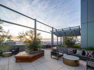 a rooftop patio with furniture and a view of the city at Oakland 1BR w AC WD Sky Deck next to BART SFO-524 in Oakland