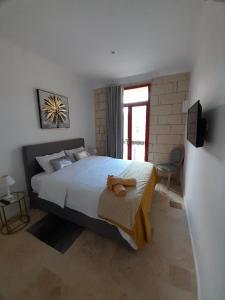 Postel nebo postele na pokoji v ubytování Palazzo Pisani Malta Boutique and SPA