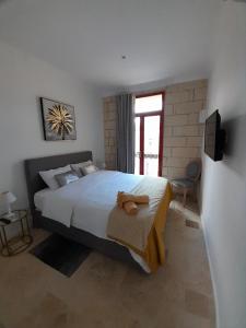a bedroom with a large bed and a window at Palazzo Pisani Malta B&B in Żabbar
