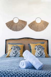 a bed with a blue comforter and two pillows at Grande Maison Gannat - Maison ou Appartements en Centre ville in Gannat