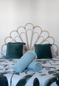 a bed with blue pillows on top of it at Grande Maison Gannat - Maison ou Appartements en Centre ville in Gannat