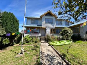 a house with a kayak in front of it at Purple Fox in Ancud
