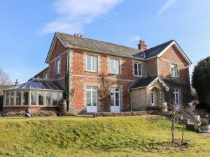 an old brick house on a grassy hill at The Downwood in Blandford Forum