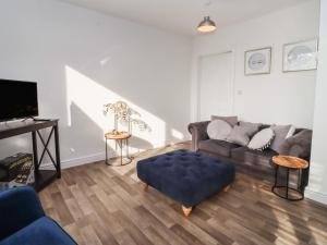 a living room with a couch and a table at Dreamwood in Blandford Forum