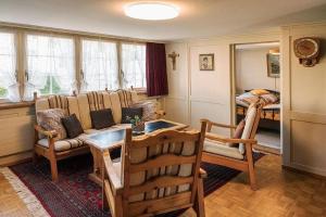 a living room with a couch and a table and chairs at Ferienhaus Wühre in Appenzell