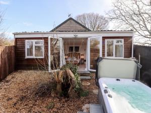 a small house with a bath tub in the yard at Meadow in Blandford Forum