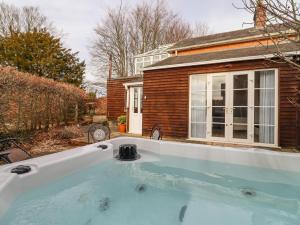 a hot tub in the backyard of a house at Snowdrop in Blandford Forum