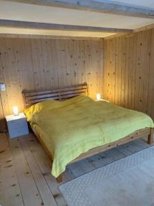 a bedroom with a bed in a wooden wall at Haus Stelz in Nesslau