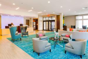 a lobby with chairs and tables and a waiting room at Fairfield Inn & Suites by Marriott Savannah Downtown/Historic District in Savannah