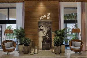 a lobby with a door with a picture of a man at The Ben, Autograph Collection in West Palm Beach