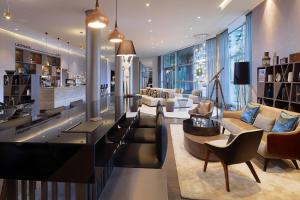 a large living room with couches and chairs at Le Méridien Hamburg in Hamburg