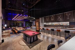 a casino with a pool table and a bar at Moxy Taichung in Taichung