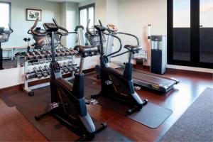 a gym with several treadmills and cardio machines at AC Hotel Algeciras by Marriott in Algeciras