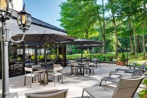 an outdoor patio with tables and chairs and umbrellas at Portland Sheraton at Sable Oaks in South Portland