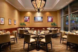 a dining room with tables and chairs and a chandelier at Marriott Salt Lake City Center in Salt Lake City