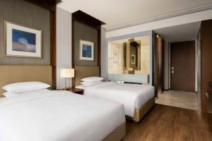 a hotel room with two beds and a mirror at Courtyard By Marriott Seoul Times Square in Seoul