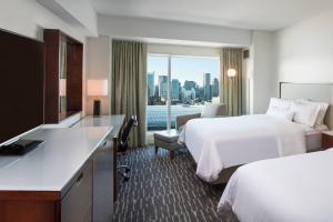 a hotel room with two beds and a large window at The Westin Boston Seaport District in Boston