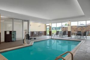 a swimming pool with blue water in a building at Fairfield by Marriott Inn & Suites Lebanon Near Expo Center in Lebanon