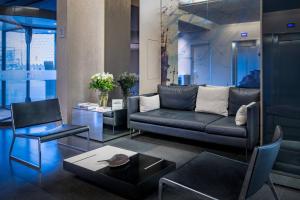 a living room with a black couch and a table at AC Hotel Sants by Marriott in Barcelona