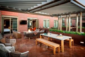 a patio with a table and chairs and a couch at The Elizabeth Hotel, Autograph Collection in Fort Collins