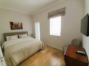 TV a/nebo společenská místnost v ubytování Palazzo Pisani Malta Boutique and SPA