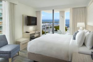 a hotel room with a bed and a television at Courtyard Miami Coconut Grove in Miami