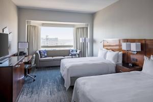 a hotel room with two beds and a couch at Richmond Marriott in Richmond