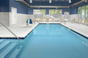a swimming pool with blue water in a building at Element Portland Beaverton in Beaverton
