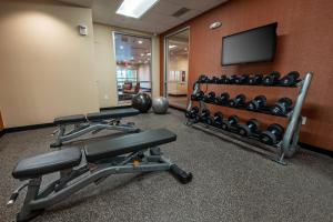 a gym with exercise equipment and a flat screen tv at TownePlace Suites by Marriott Toledo Oregon in Oregon